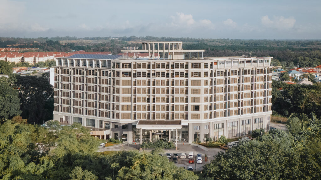 Aerial drone view of Livingston Hotel Sandakan showing the entire hotel building and surroundings