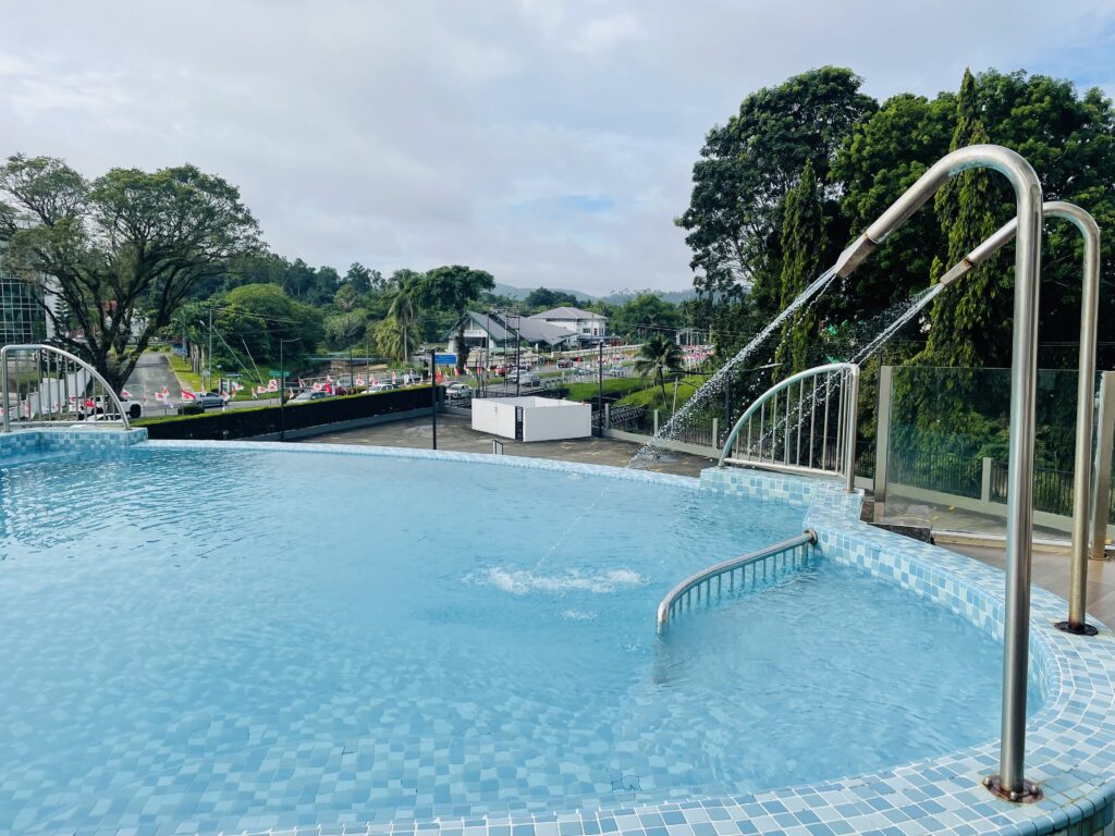 Daytime view of swimming pool at Livingston Hotel Sandakan with clear water and surroundings