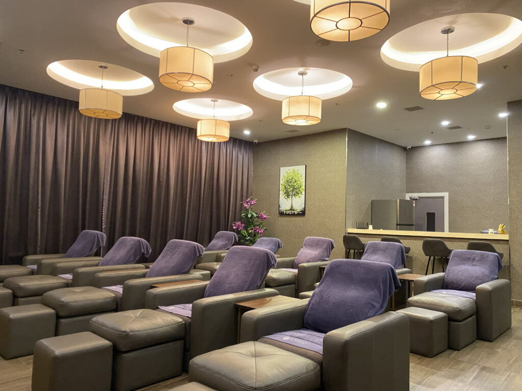 Foot massage area at Aroma Wellness & Spa, Livingston Hotel Sandakan showing massage chairs and relaxing ambiance