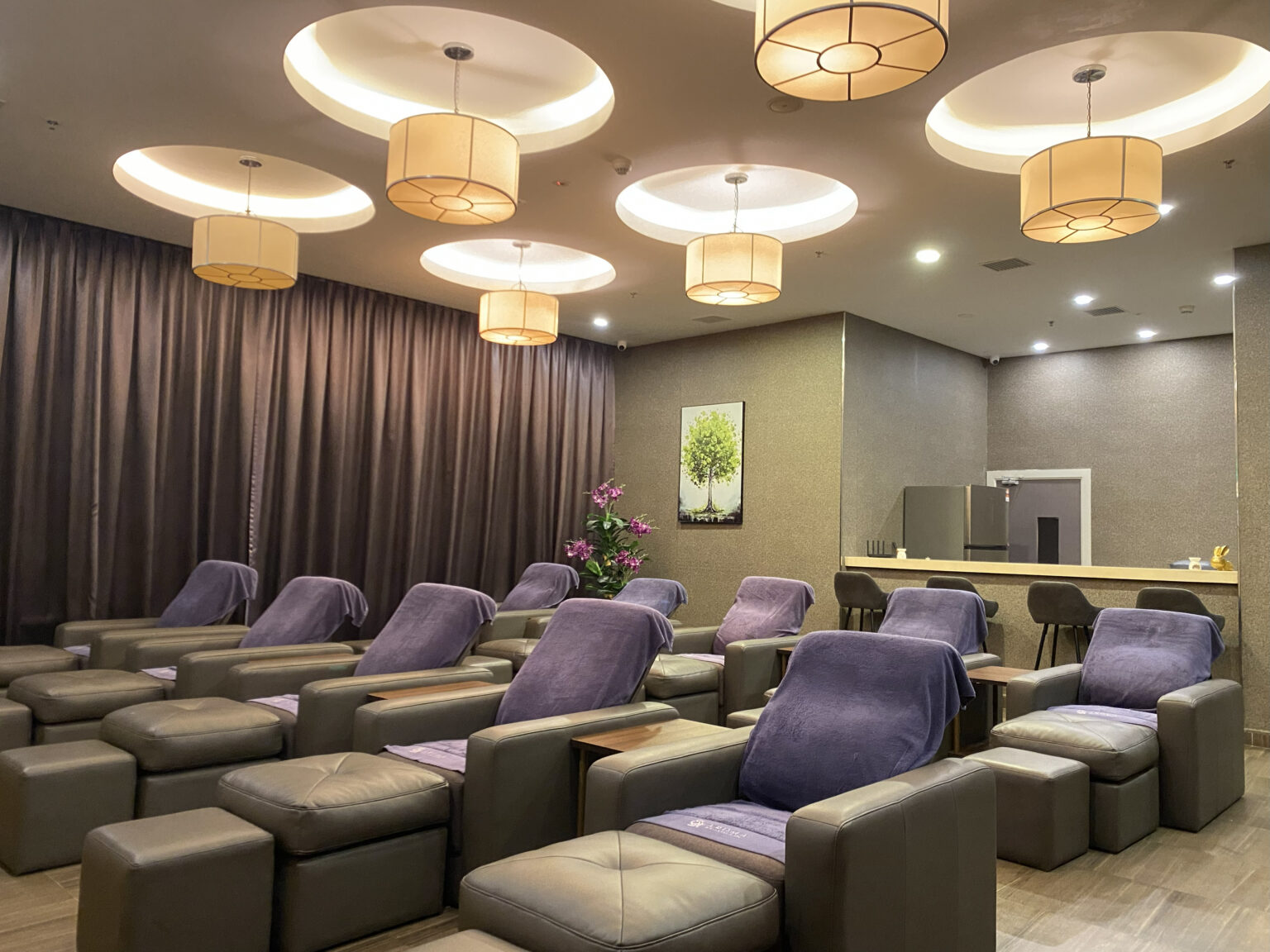 Foot massage area at Aroma Wellness & Spa, Livingston Hotel Sandakan showing massage chairs and relaxing ambiance