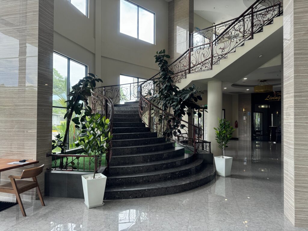 Livingston Hotel lobby staircase with elegant iron railing and high ceiling