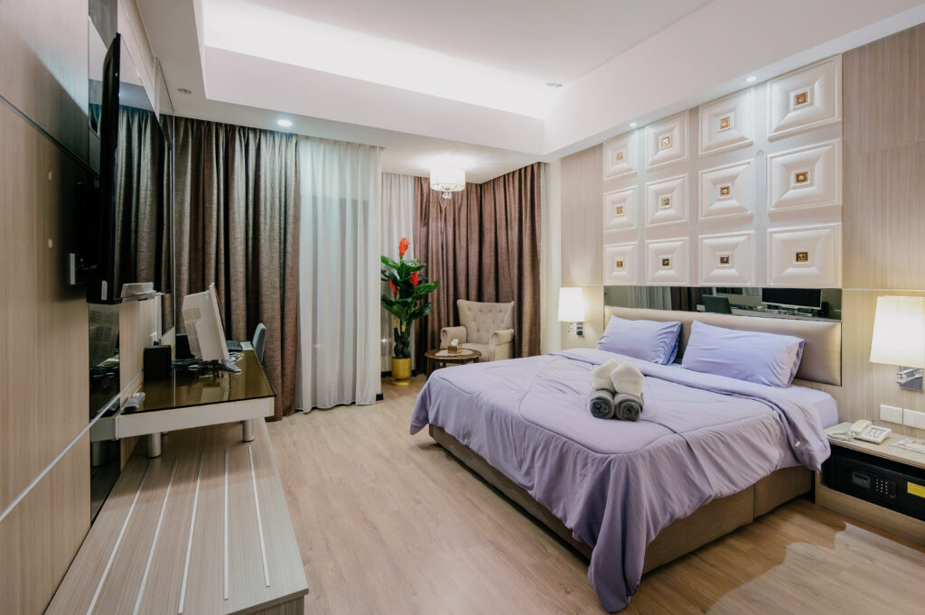 Caribbean Suite at Livingston Hotel Sandakan showing bed, sofa, and flower decoration