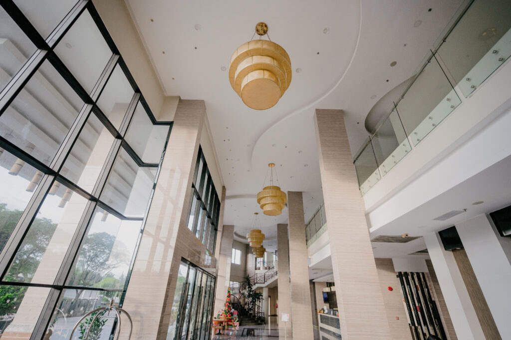 Livingston Hotel lobby with high glass ceiling and elegant pendant lighting