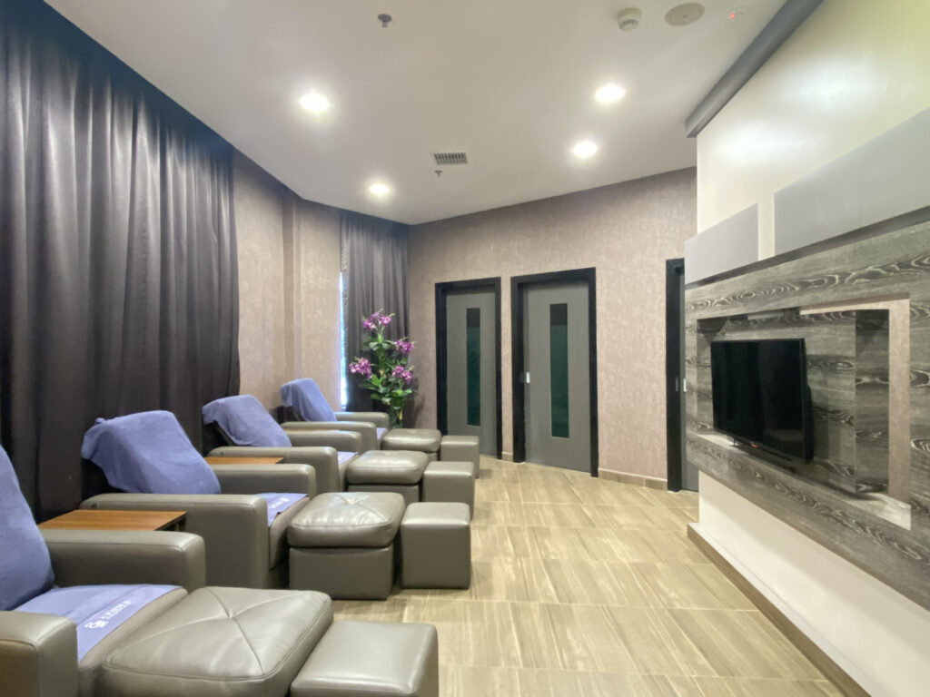 VIP Room at Aroma Wellness & Spa, Livingston Hotel Sandakan showing rotatable TV and living area