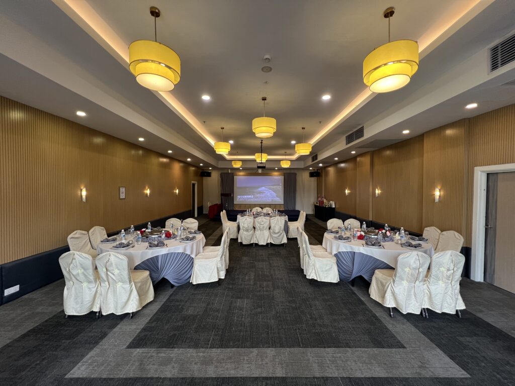 Hotel function room with built-in stage setup for presentations, performances, or corporate events